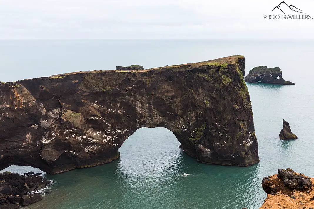 Rock arch in the sea on the coast of Dyrhólaey