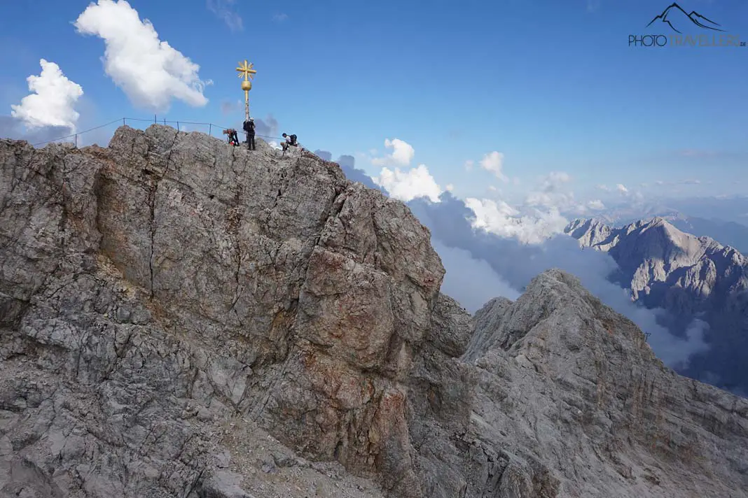 The view of the golden summit cross of the Zugspitze