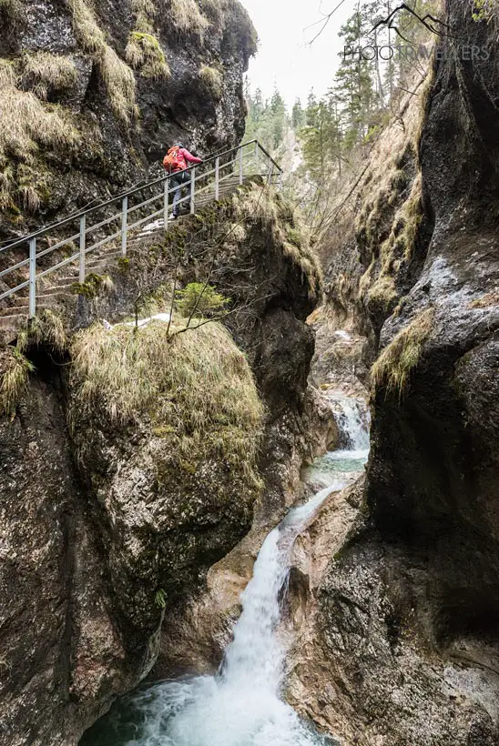 A staircase with a hiker in the Almbachklamm gorge