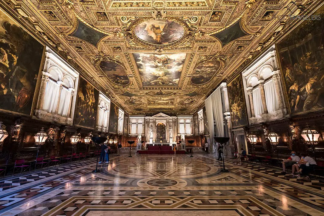 A golden room with paintings in the Scuola Grande di San Rocco
