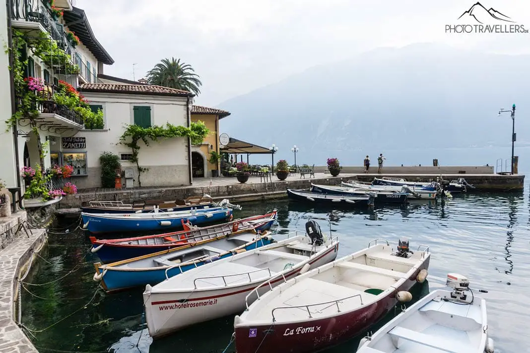 Colorful rowing boats in the small harbor of Limone on Lake Garda