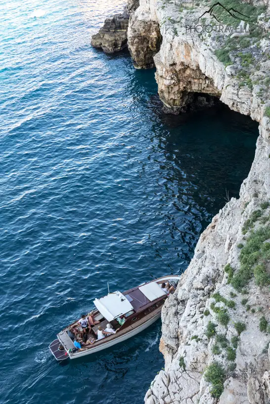 Ein Boot vor einer Grotte unterhalb von Polignano a Mare