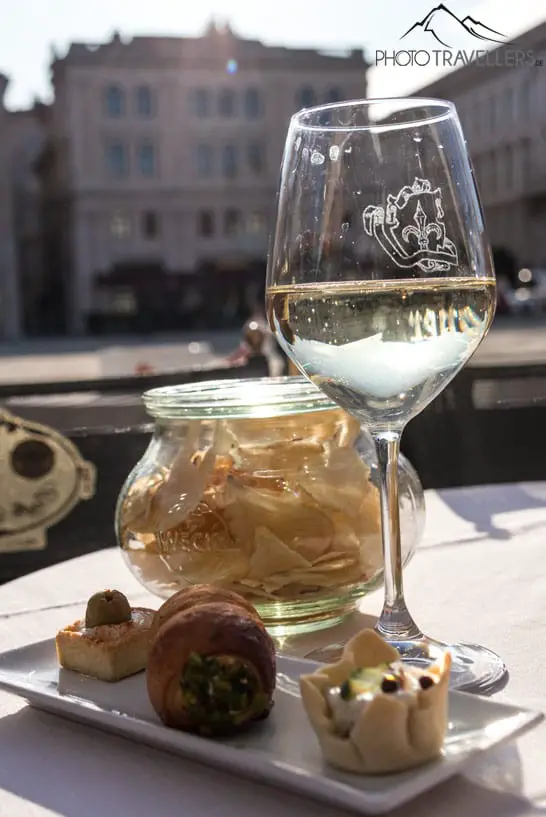 Eine Weinschorle mit Chips im Caffè degli Specchi am Hauptplatz