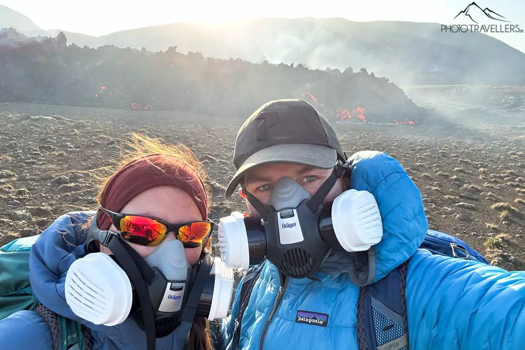 Die Reiseblogger Biggi Bauer und Florian Westermann mit Gasmasken am Vulkanausbruch in Island