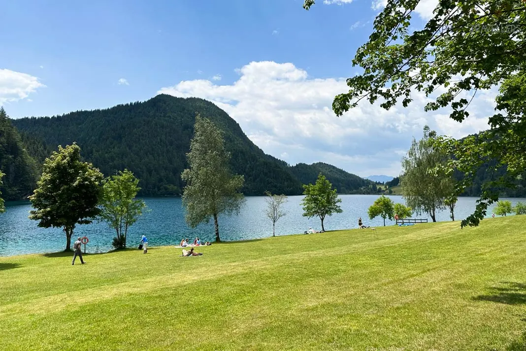 Blick auf die grüne Liegewiese vor dem Hintersteiner See am Wilden Kaiser