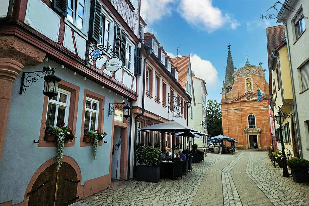 Gastwirtschaften und eine Kirche reihen sich an der gepflasterten Schlossgasse aneinander