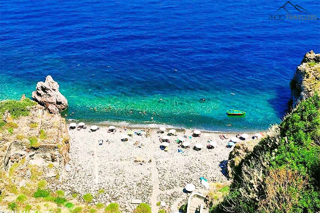 Blick von oben auf den Strand Spiaggia dello Scario, der zwischen Felsen und türkisem Wasser eingebettet ist 